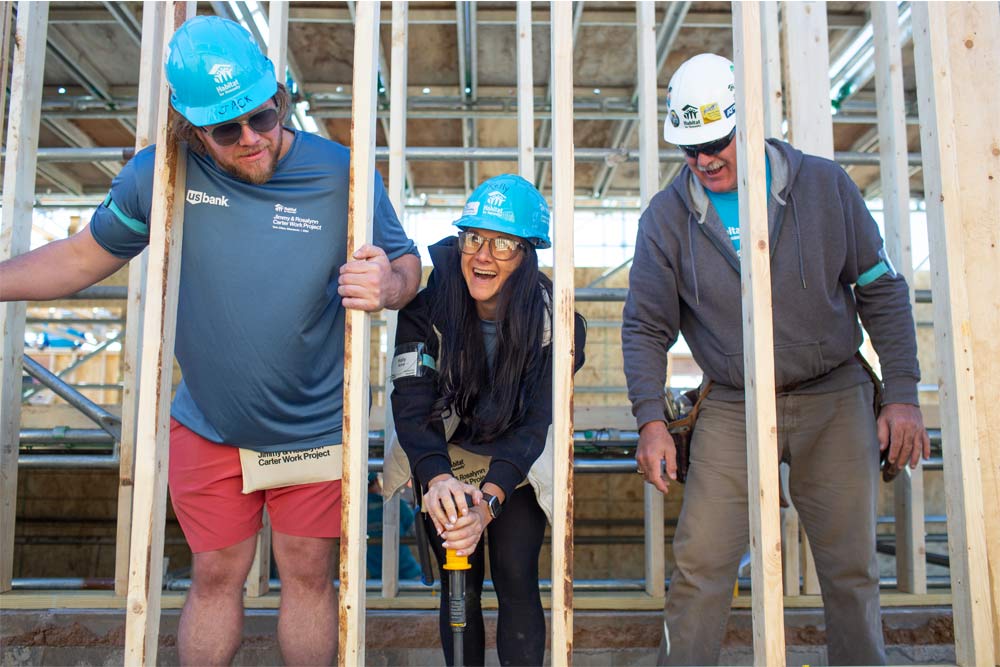 People building a house at a Habitat site