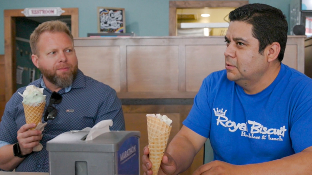 Two men eating ice cream cones