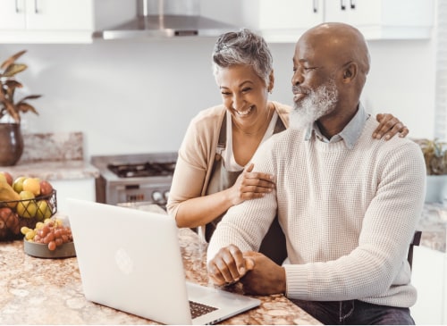 Husband and wife using laptop