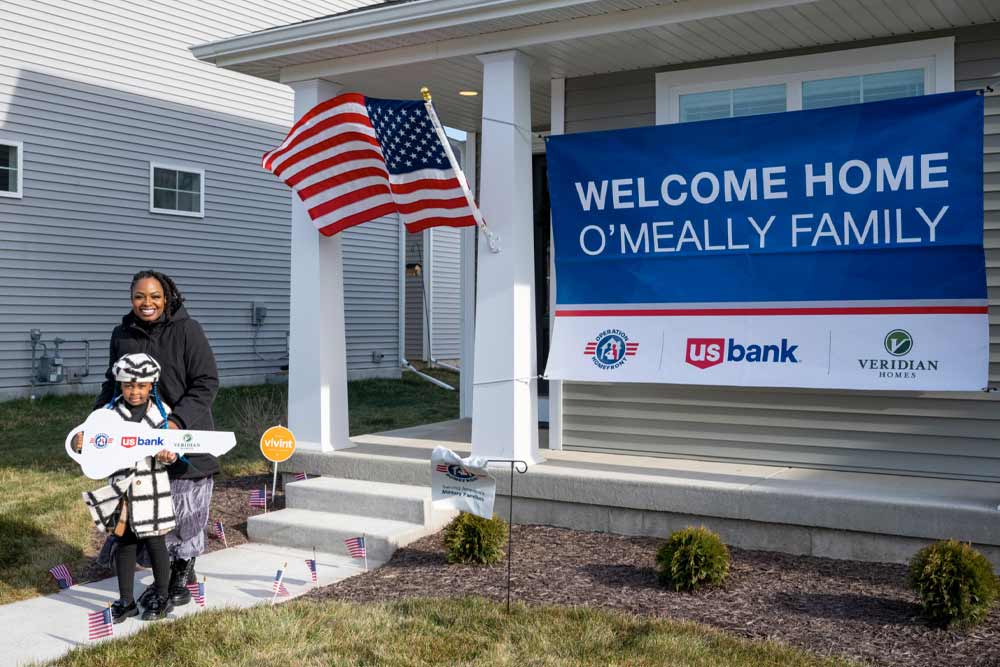 Mother and daughter pictured outside of their new home