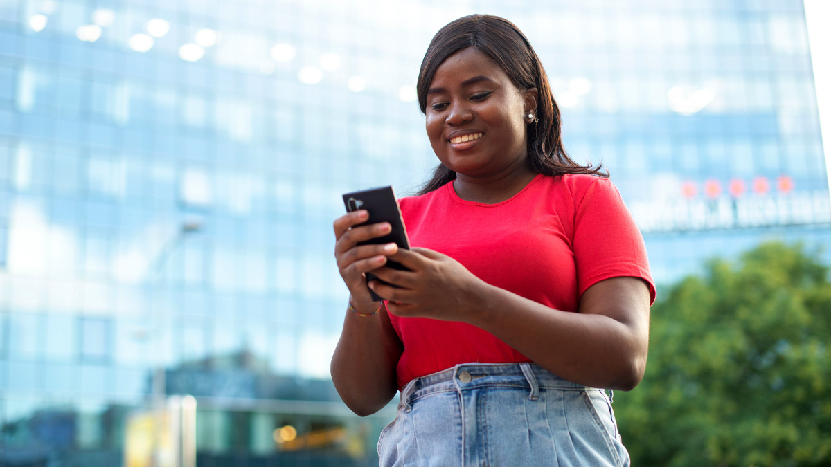 Woman looking at phone and smiling.