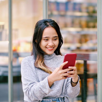 Woman smiling looking at phone