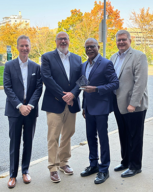 Four men standing together