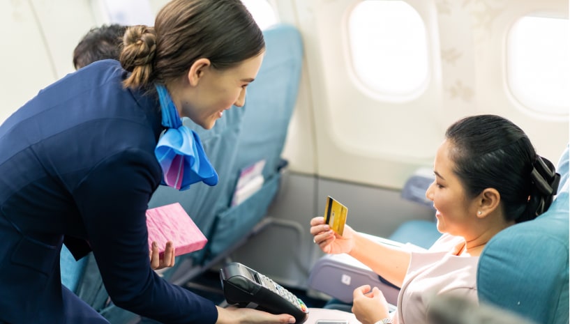 Airline passenger using credit card to pay for an item while in mid-flight