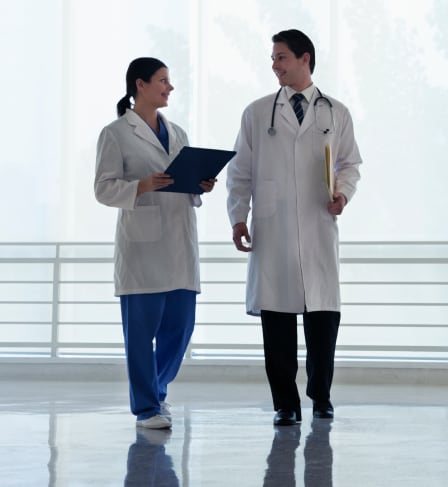 Two doctors walking down a hallway