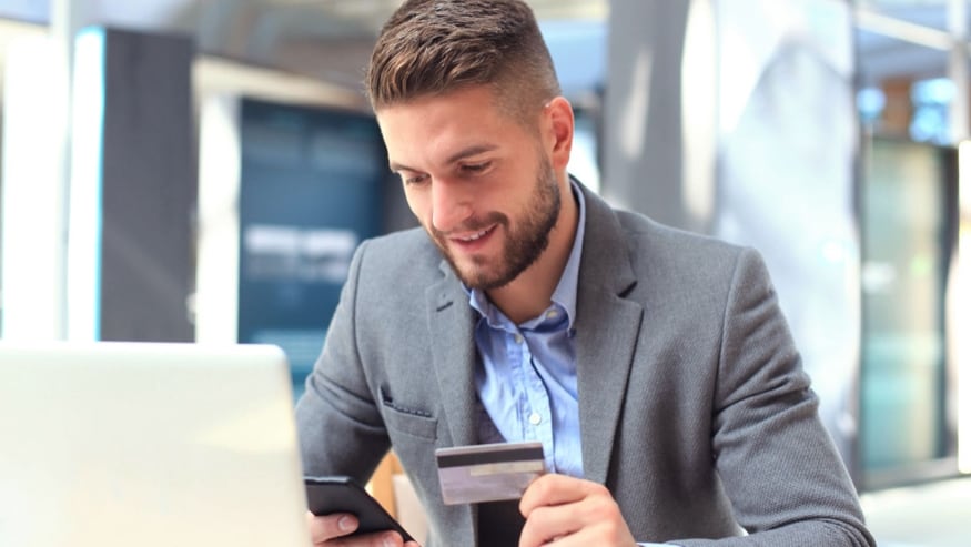 Person using a credit card to make an online purchase.