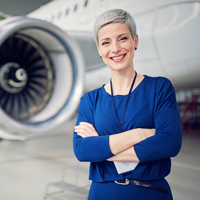 Person standing in front of a parked airplane