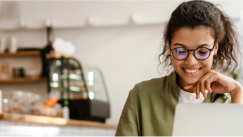 Woman smiling at a computer