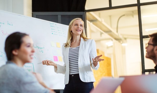 Woman giving whiteboard presentation