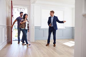 couple touring home with realtor