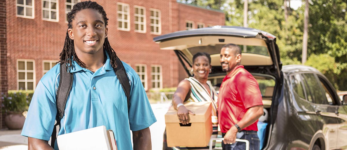 Parents dropping off student to college.