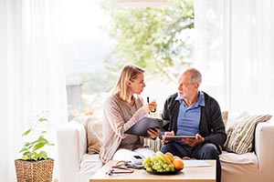 woman helping a man take his medication