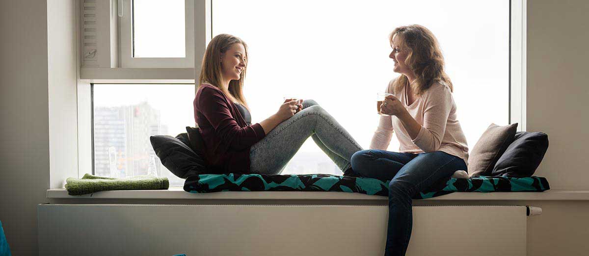 Women smiling and talking with each other.