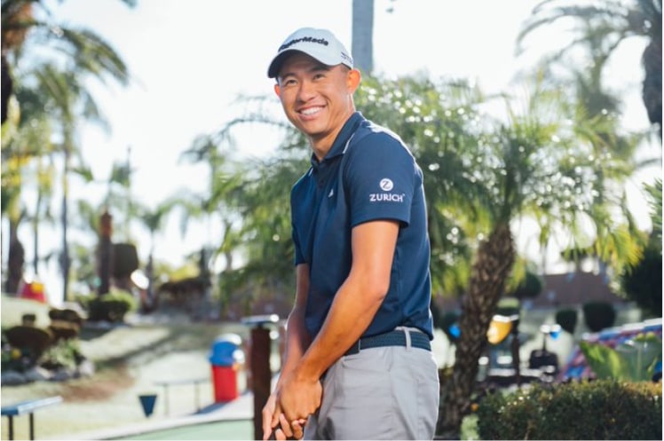 Collin Morikawa smiling with putter