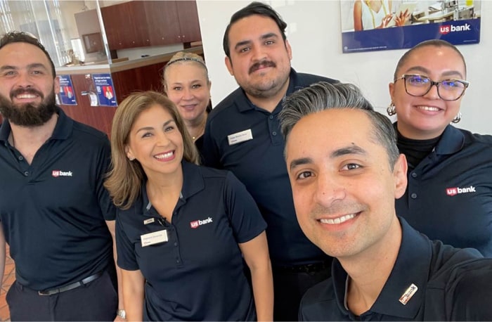 Branch manager Andres Malfavon and his team smile for a selfie in San Ysidro, California.
