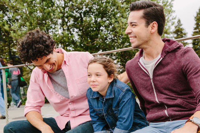 Couple smiling with middle-school aged daughter