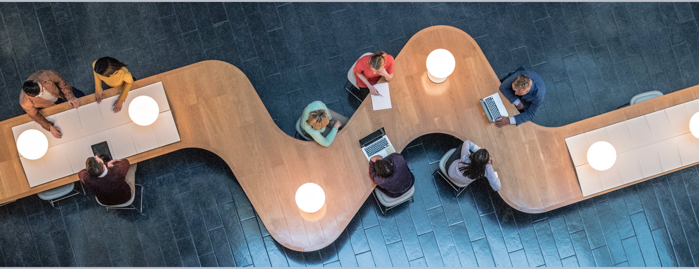 Overhead view of a large table with several people sitting.