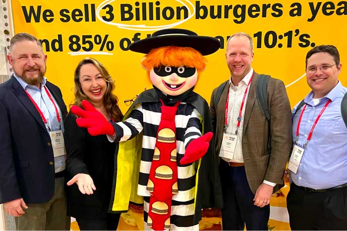 Three men and a woman standing with the Hamburglar from McDonald’s.