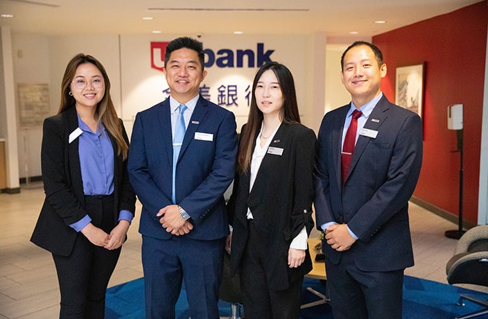 U.S. Bank employees standing together in a Chinese community branch.