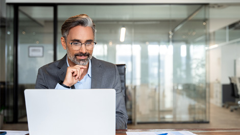 Photo of man working at laptop